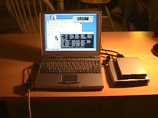 Tuxtops laptop. To the left the ethernet cable going to the network, to rhe right the external CD rom and Floppy drive